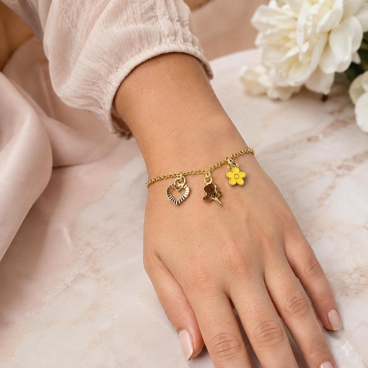 Gold charm bracelet, yellow flower, rose and heart charms