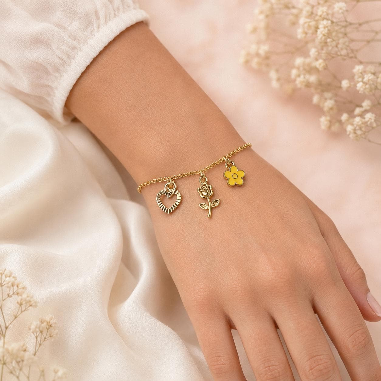 Gold charm bracelet, yellow flower, rose and heart charms